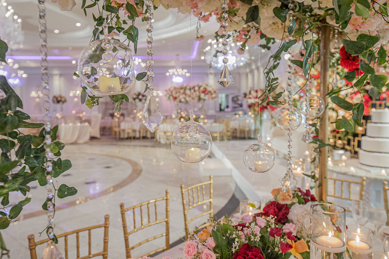 Crystal orbs and garden roses above the tables