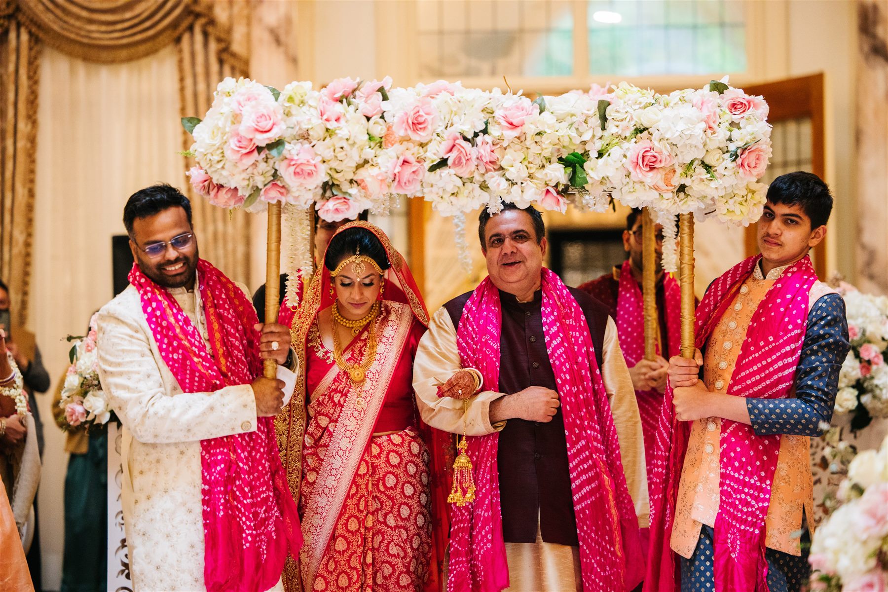 The bride enters beneath the phoolon ki chadar