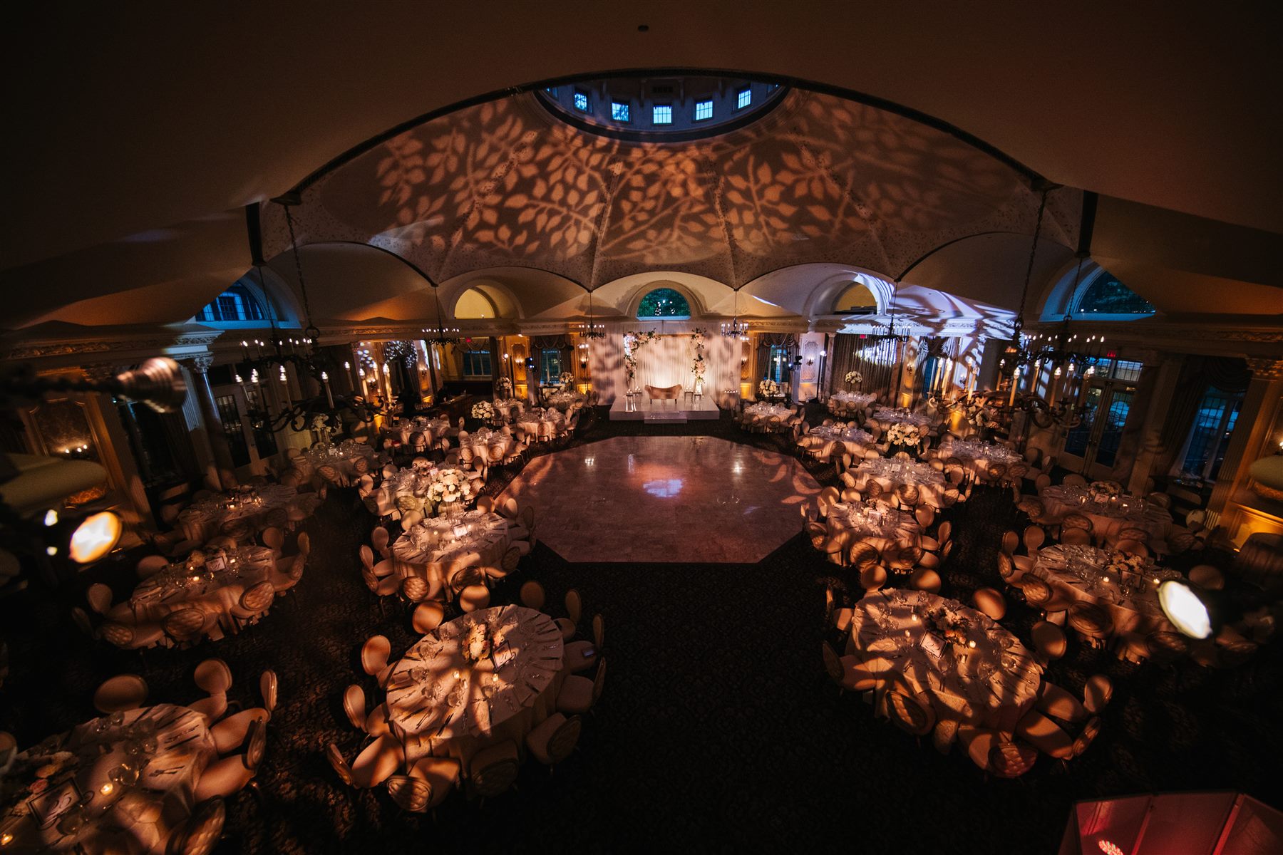 The reception tent, patterned in candlelight