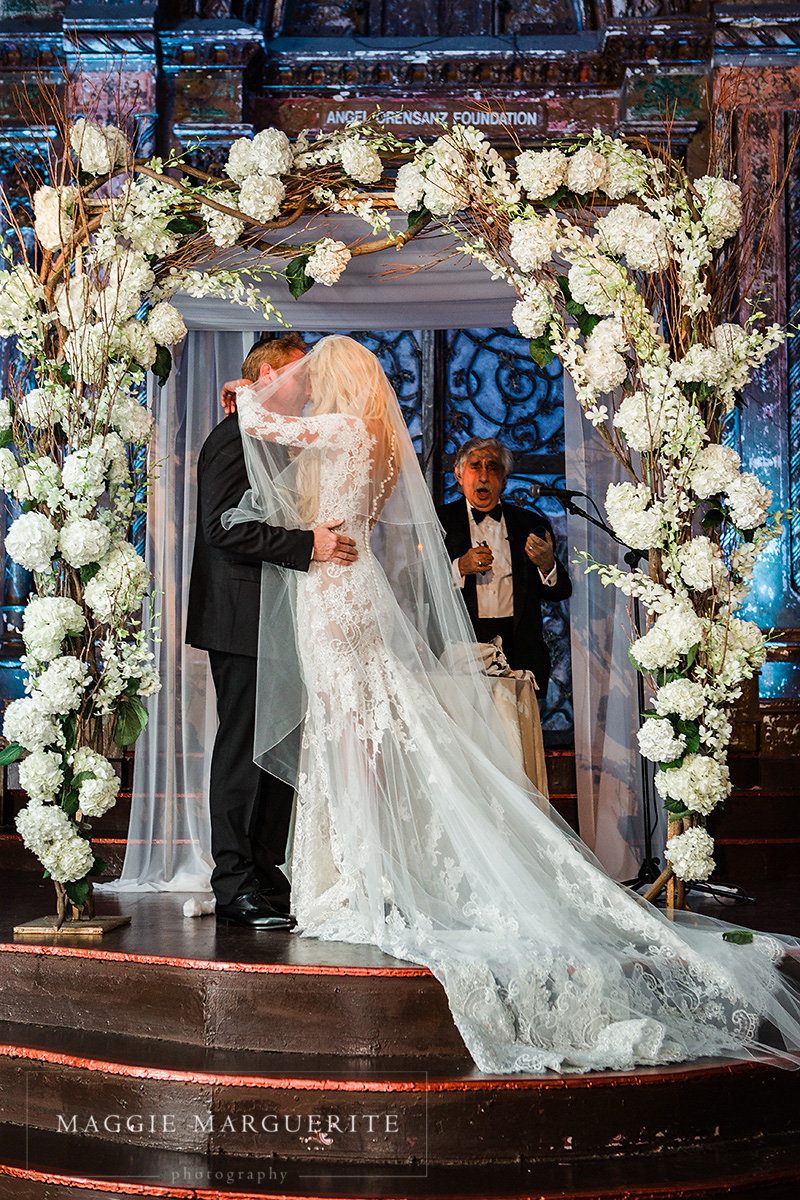 Beneath the chuppah of hydrangea and branch