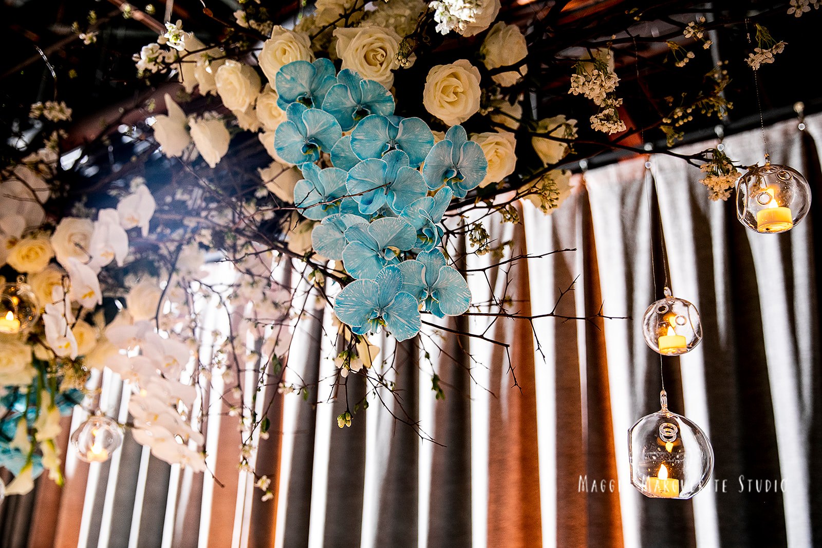 Blue orchids and cherry blossom over candlelit tables at The Lighthouse, planned by Tara M. Events